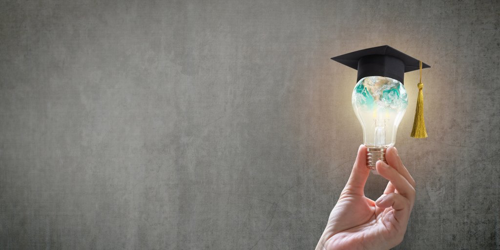 Innovative learning, creative educational study concept for graduation and school student success with world lightbulb on teacher chalkboard